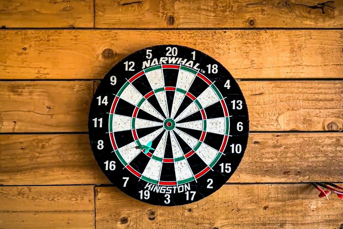 A dart landing on a dartboard